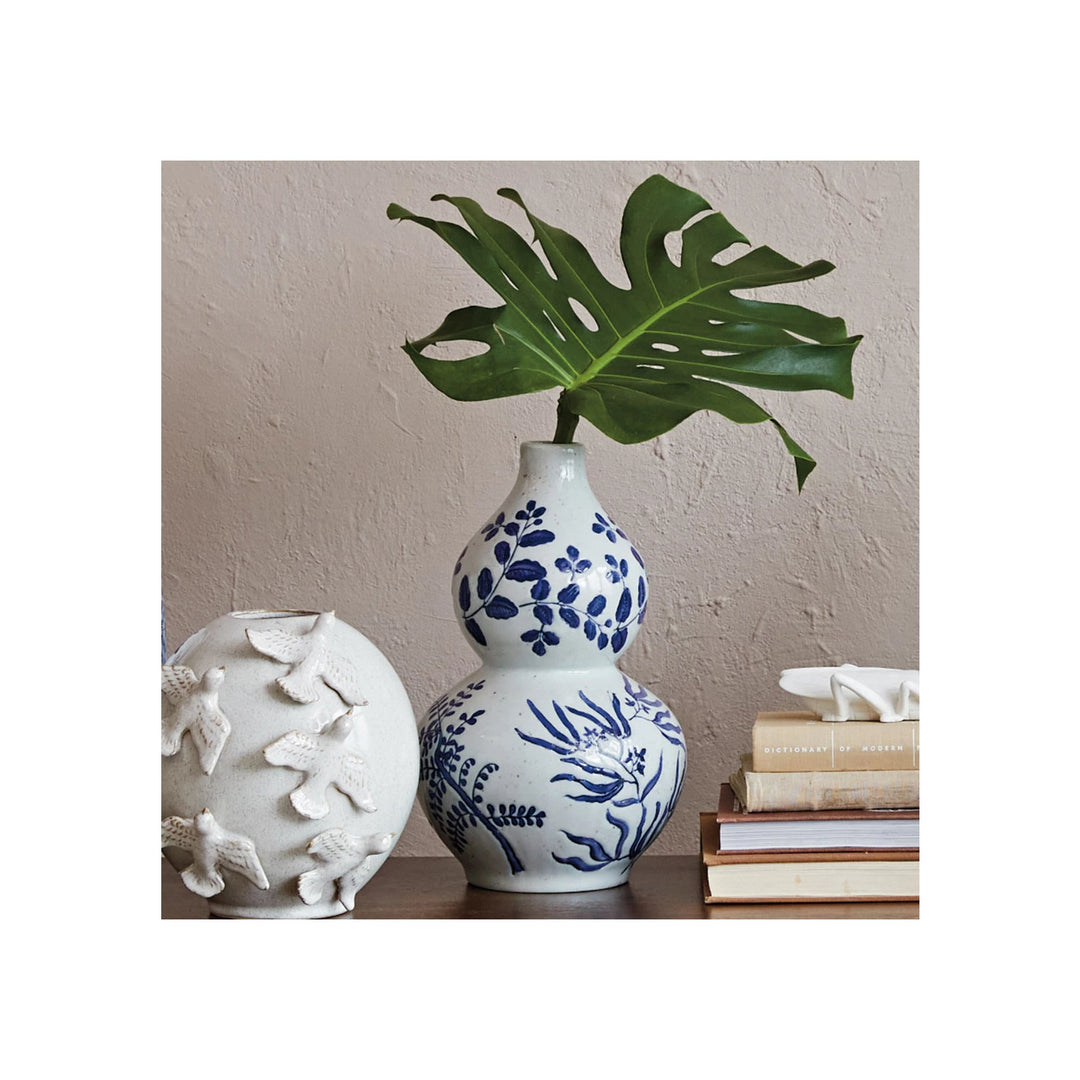 Blue &amp; white hand-painted stoneware vase with floral designs, available in small, medium, and large sizes.