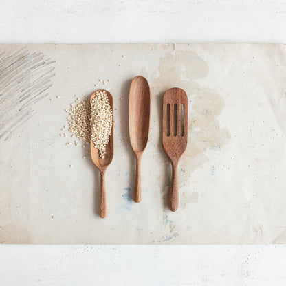 The 7"L Carved Doussie Wood Spoon, Natural, features a smooth wood finish, perfect for adding elegance to your kitchen. Size: 7 inches long.