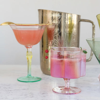12 oz. iridescent pink, pleated wine glass with red berries on the rim.