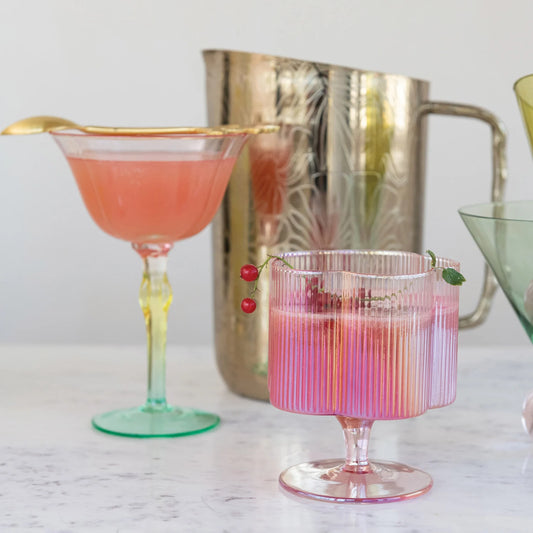12 oz. iridescent pink, pleated wine glass with red berries on the rim.