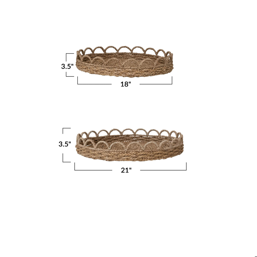 Two natural seagrass scalloped decorative trays, 18 and 21 inches in diameter and 3.5 inches tall.