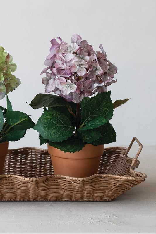 Faux hydrangea in a terracotta-style plastic pot with light purple, lifelike petals; available in 2 colors.