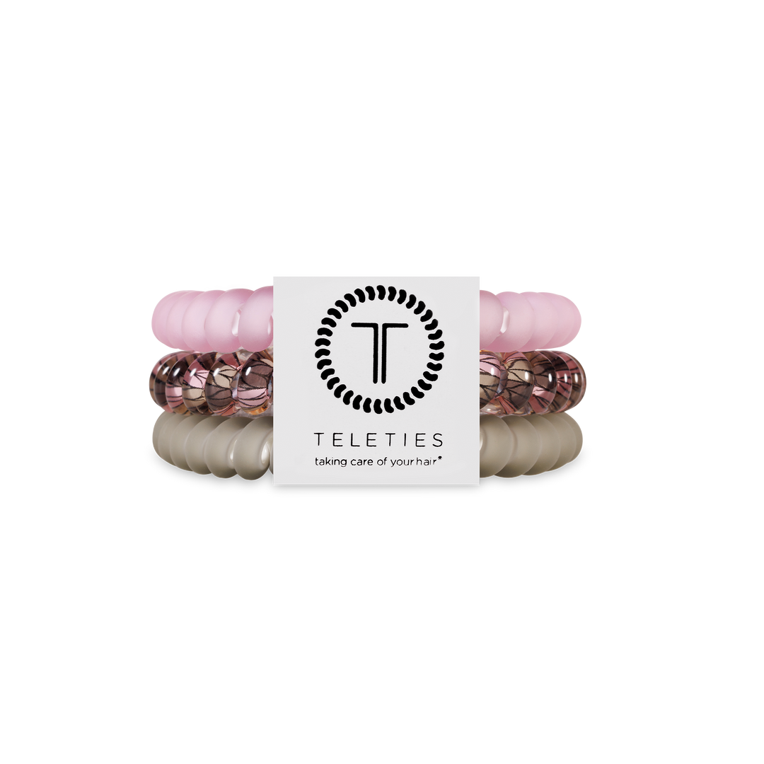 Three TELETIES Hair Ties in light pink, rose gold, and beige. Available in small and large sizes.