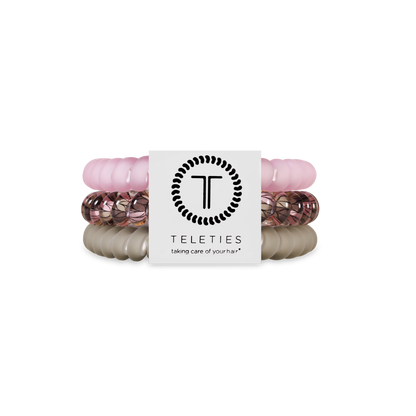 Three TELETIES Hair Ties in light pink, rose gold, and beige. Available in small and large sizes.