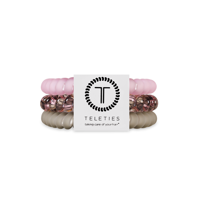 Three TELETIES Hair Ties in light pink, rose gold, and beige. Available in small and large sizes.