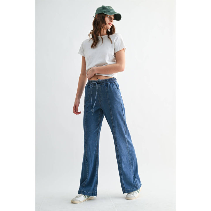 High-rise wide-leg denim joggers with elastic drawstring waist and vertical seams. Size XS.