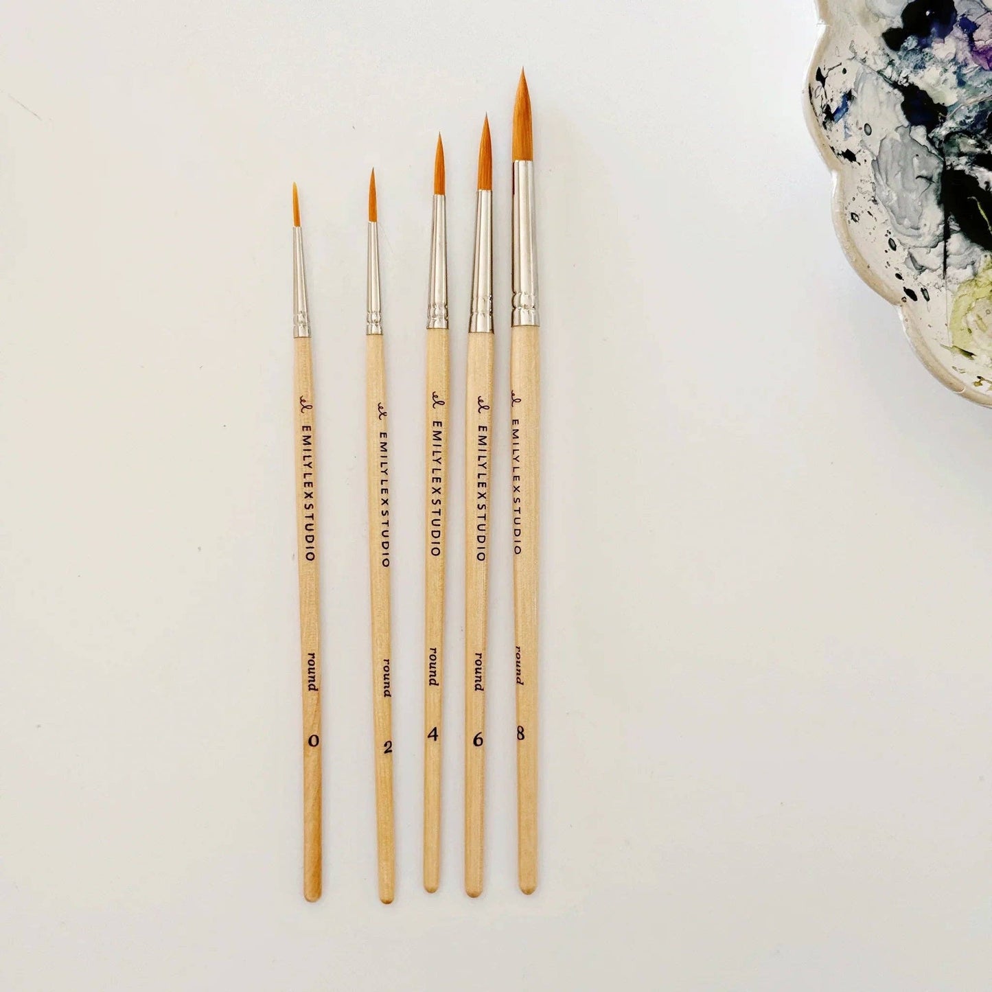 Set of five wood watercolor brushes with synthetic taklon bristles in assorted sizes.