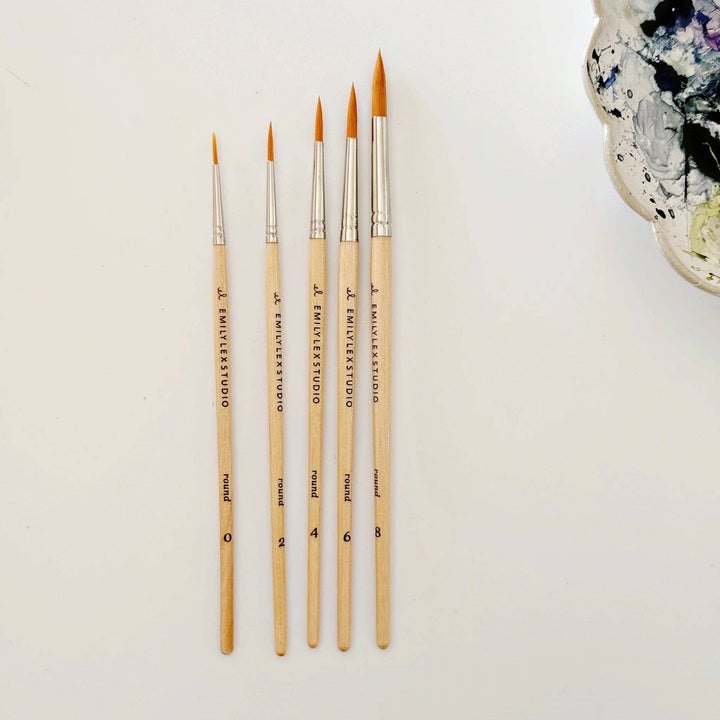 Set of five wood watercolor brushes with synthetic taklon bristles in assorted sizes.
