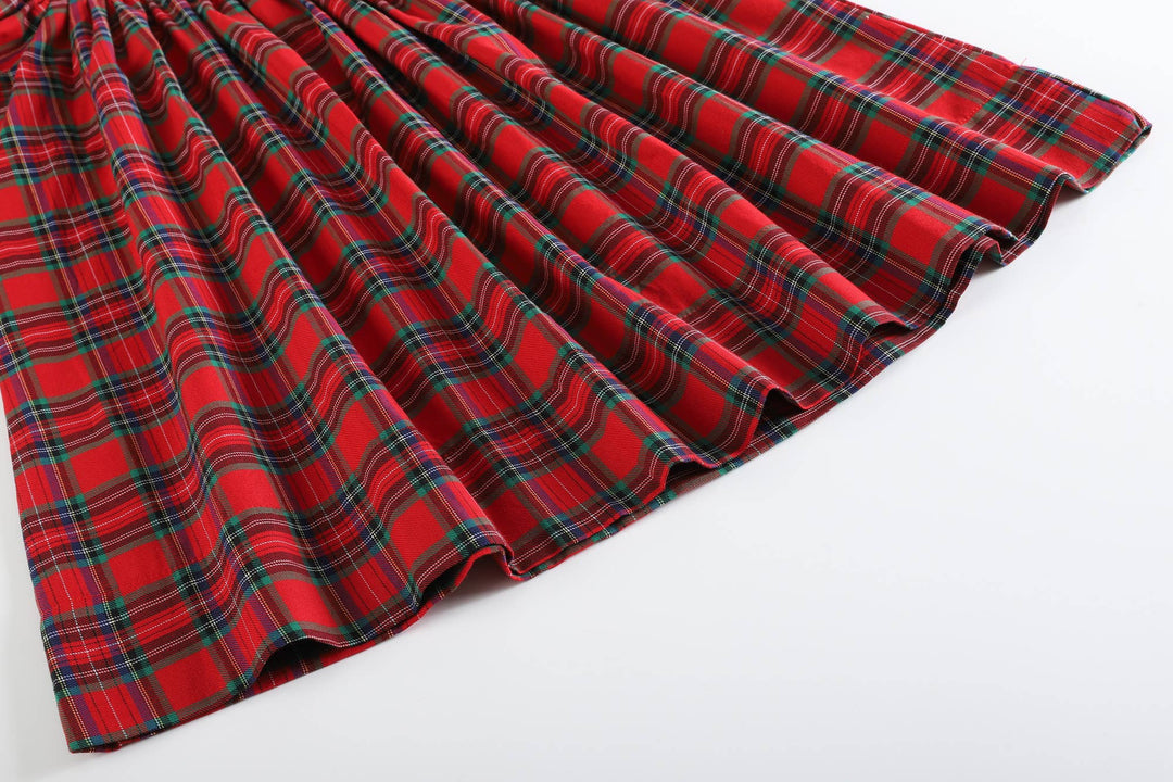 Red Christmas Plaid Smocked Bishop Dress in red plaid with green, yellow, and white stripes, smocked top with wavy hem. Size: 2T.