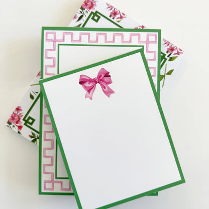 5"x7" Pink & Green Greek Key Border Notepad with green border, floral patterns, pink bow, on bright white paper.
