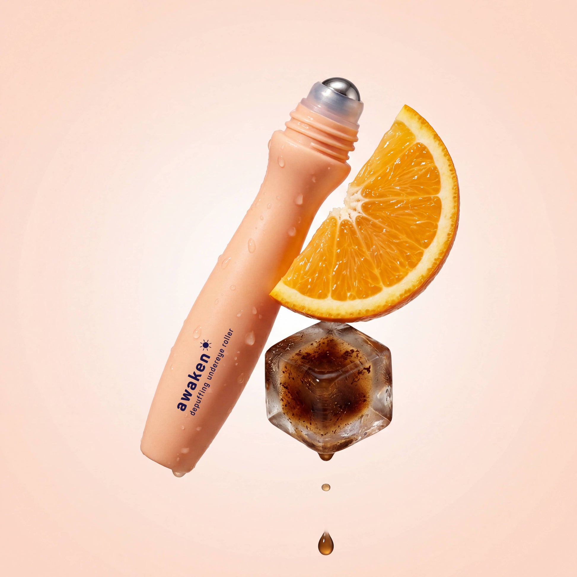 Peach-colored bottle labeled “awaken,” featuring the Depuffing Under Eye Roller with Caffeine & Vitamin C; available in 10ml and 15ml sizes.