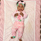 Baby modeling set on crib, baby is smiling big!