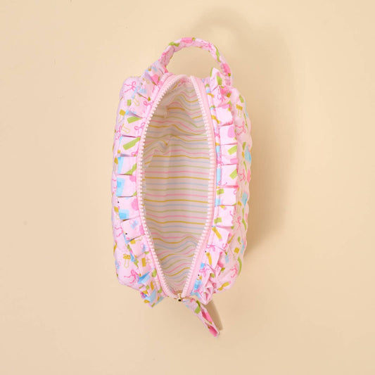Small pastel pink quilted pouch with ruffled edges, zipper closure, fabric handle, striped wipeable lining. Sizes: one size.