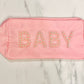 Pink nylon bag with "BABY" in pearl-adorned letters. Features a smooth texture and gold zipper pull. Sizes: Small, Medium, Large.