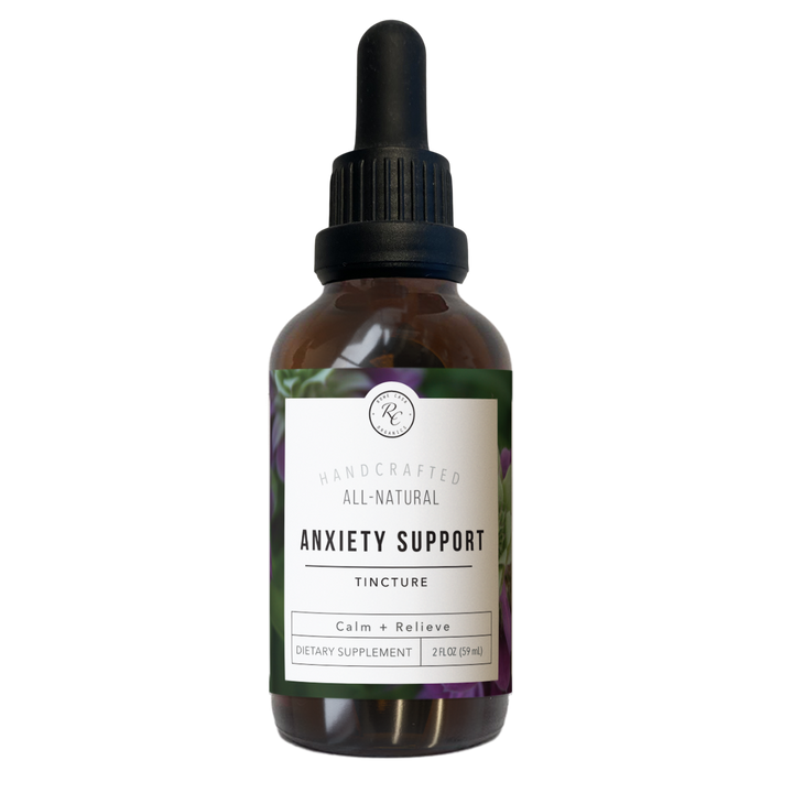 A brown glass dropper bottle labeled “ANXIETY SUPPORT TINCTURE | 2 OZ,” with indications of calm and relieve, dietary supplement information, handcrafted all-natural branding, and available in a 2 oz size.