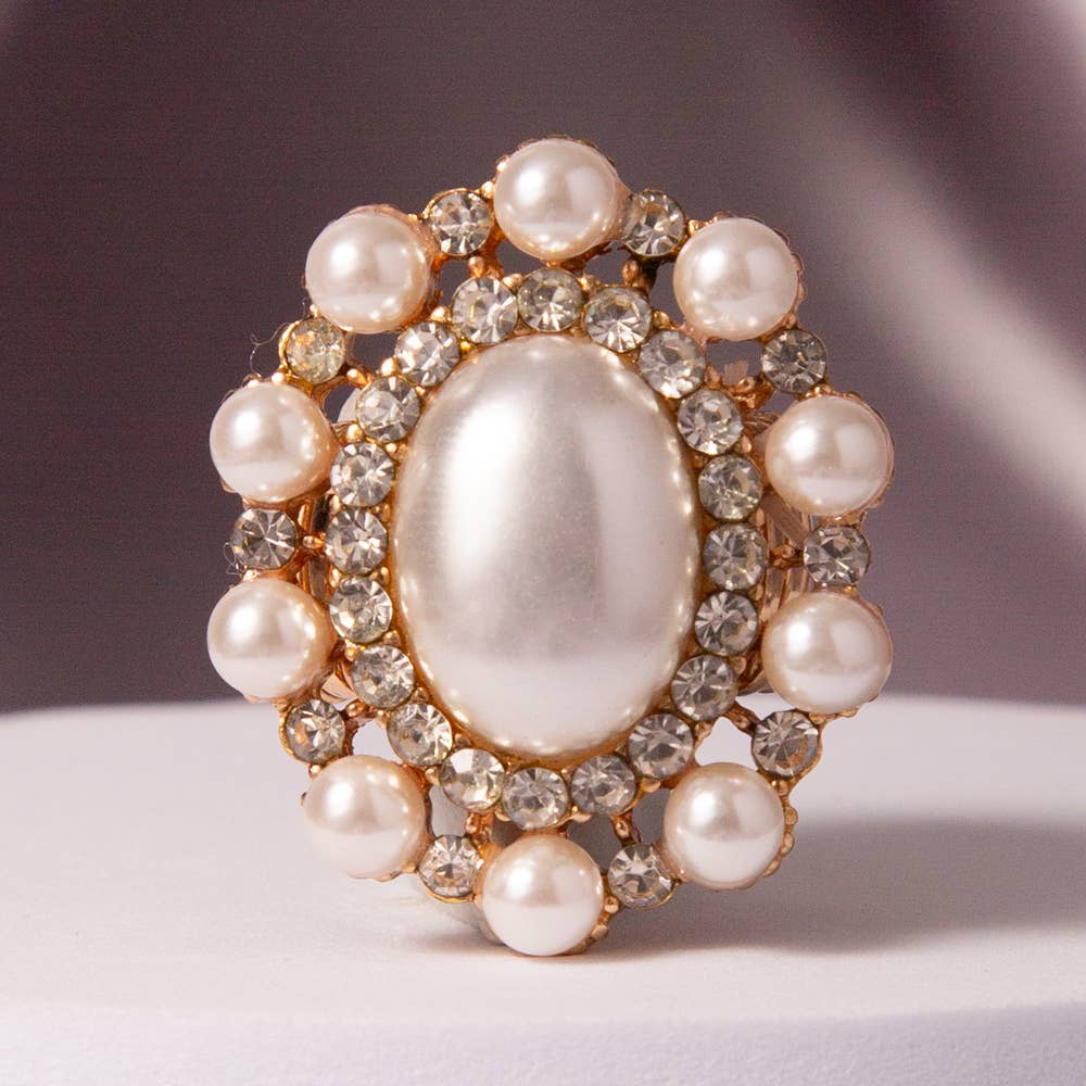 Oval Crystal Sunburst Double Halo Stretch Ring with central oval crystal, clear rhinestones, round pearls. Sizes: stretch fit.
