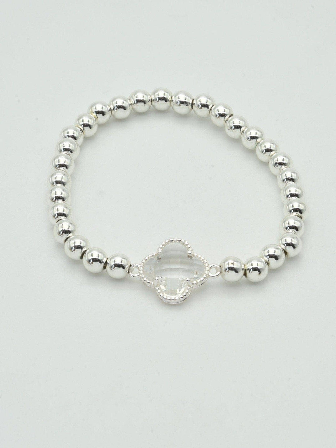 Gold and silver beaded bracelet with a crystal clover charm. Available sizes: S, M, L.