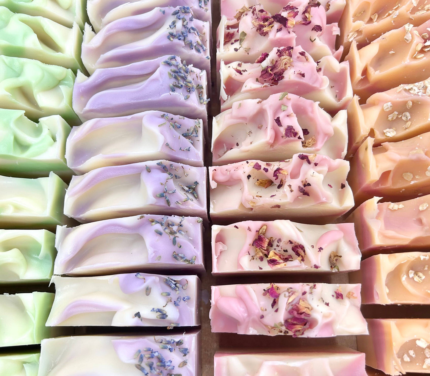 Bamboo Bergamot Handmade Soap Bars are available in a colorful array of pastel green, purple, pink and cream hues. Vegan-friendly and created using the cold process method, some bars are topped with dried flowers and herbal sprinkles. All sizes available.