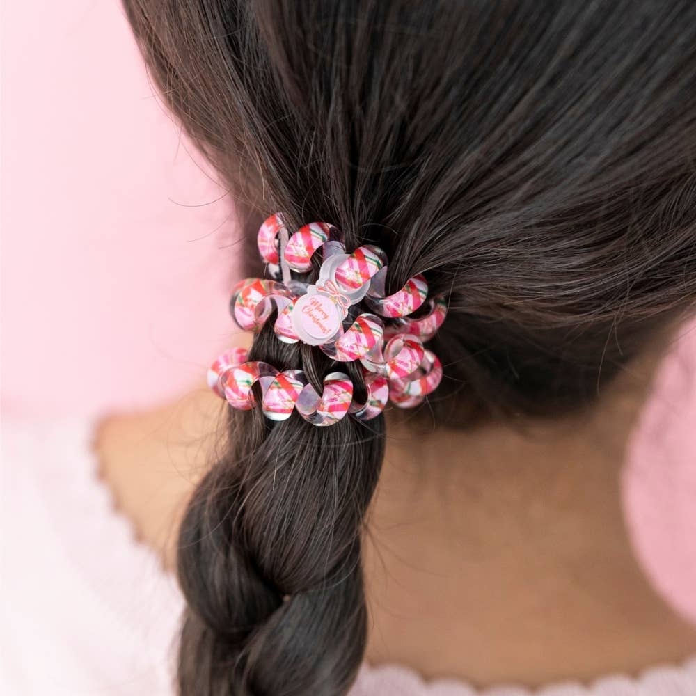 And to All a Good Night hair ties, large, featuring a red and white candy cane stripe pattern and a “Merry Christmas” tag.