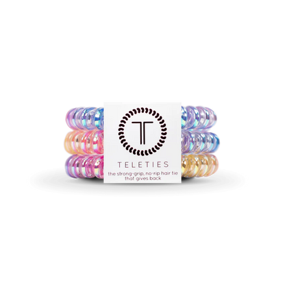 TELETIES Hair Ties: Colorful, glossy coiled hair accessories in pastel pink, blue, purple, and yellow. Offer strong grip and no-rip use. Available sizes: Small and Large.