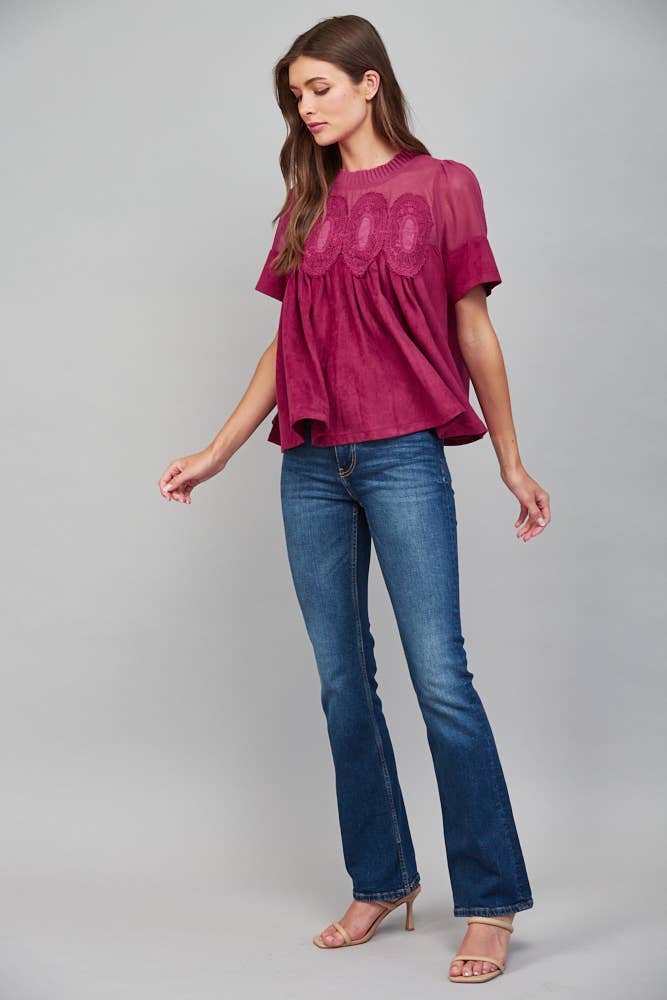 Teal blue short-sleeve faux suede top with a sheer mesh yoke and lace appliqué detail. Available in all sizes.