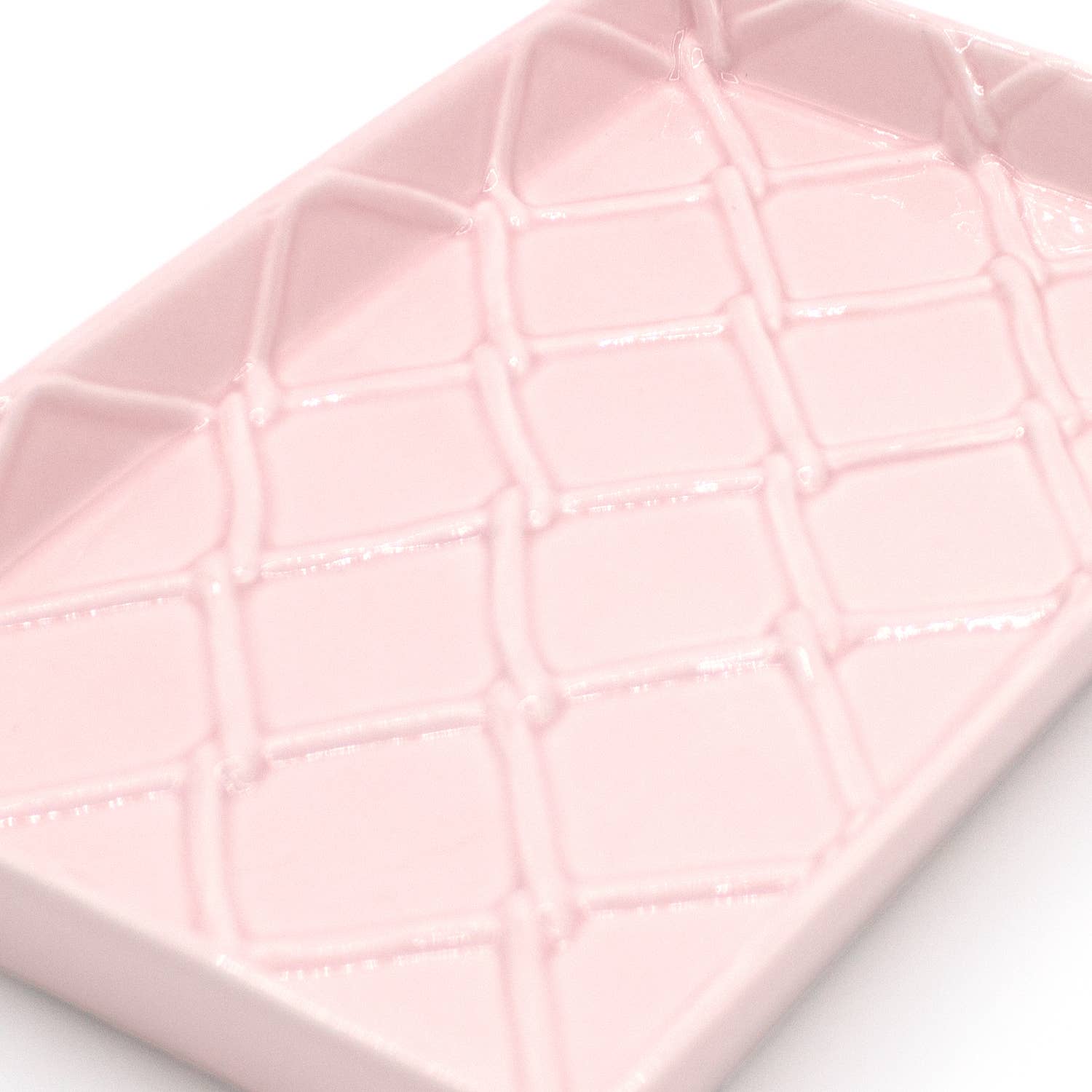 Rectangular, light pink ceramic guest towel tray with raised diamond pattern; available in standard size.