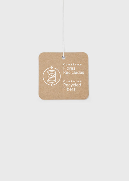 Brown square tag with white text, “Contiene Fibras Recicladas” and “Contains Recycled Fibers,” plus a spool-and-arrows icon; for Baby Girl Floral Printed Velvet Dress, available in sizes 0-3M to 18-24M.