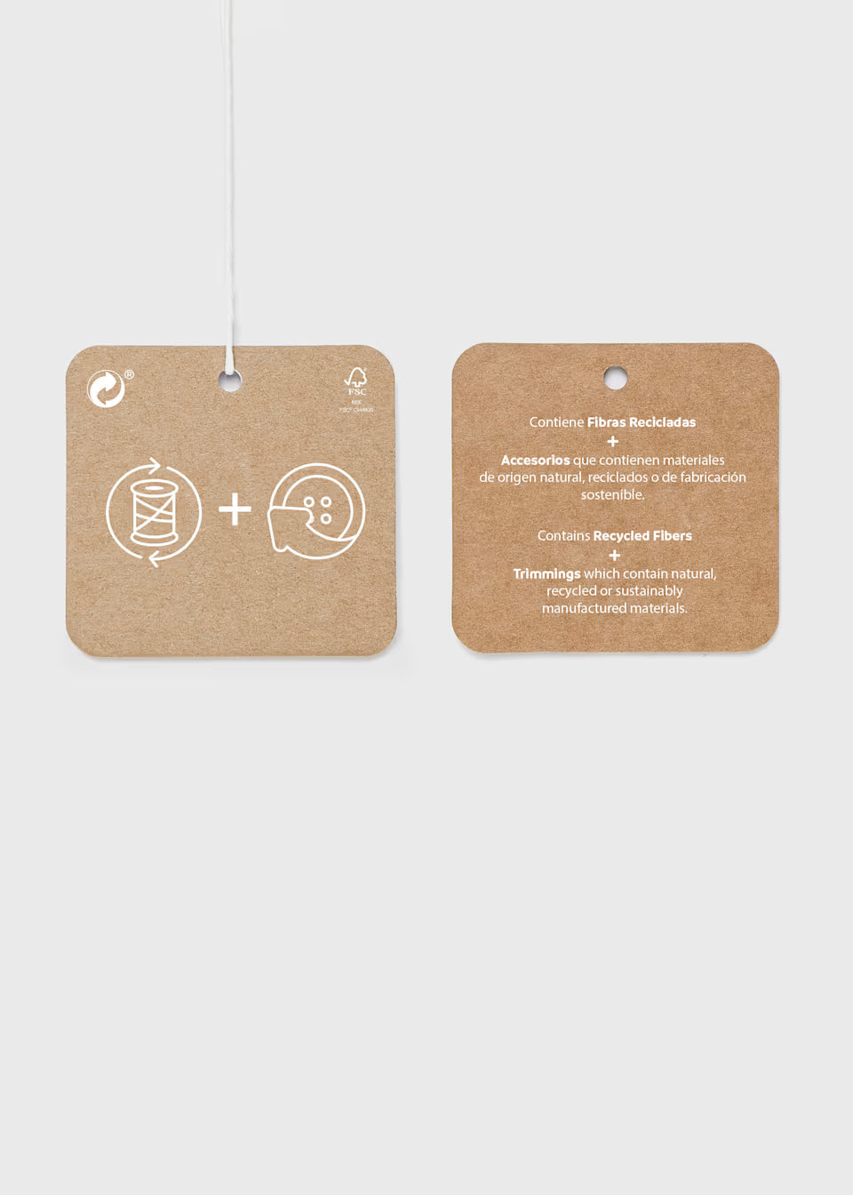 Two brown square hang tags with white icons and text for Little Girl Twill Scallop Pants. Icons represent craftsmanship, and note recycled fibers in Spanish and English. Available sizes: 2T–6X.