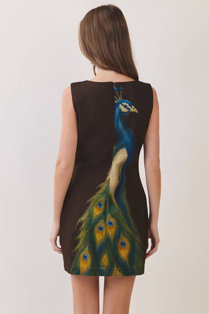Sleeveless Chocolate Peacock Print Mini Dress with vibrant peacock design on the back. Available in sizes XS–L.