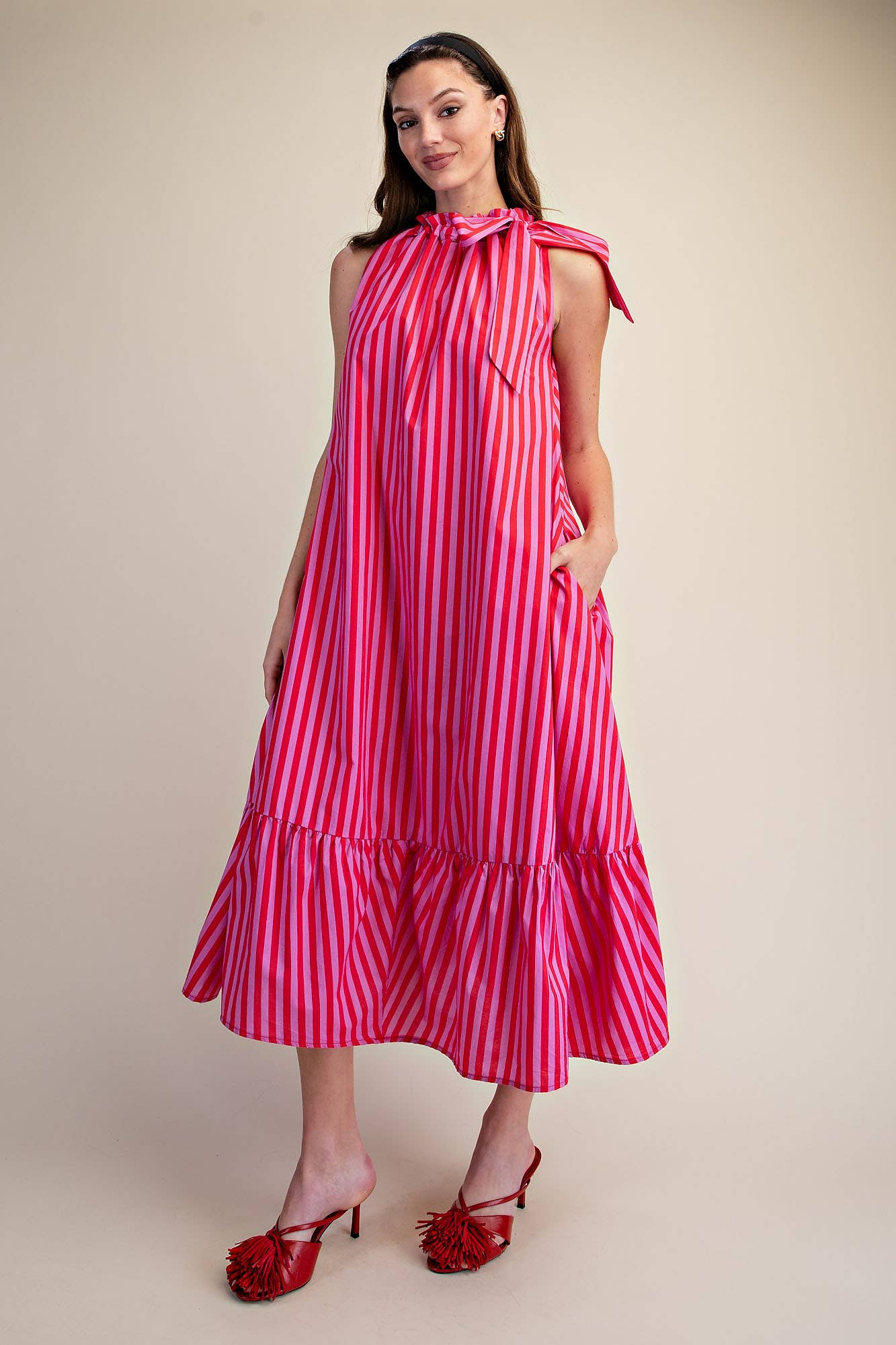 Navy Stripe Midi Dress with sleeveless ruffle neck tie. Available in sizes XS-XL.
