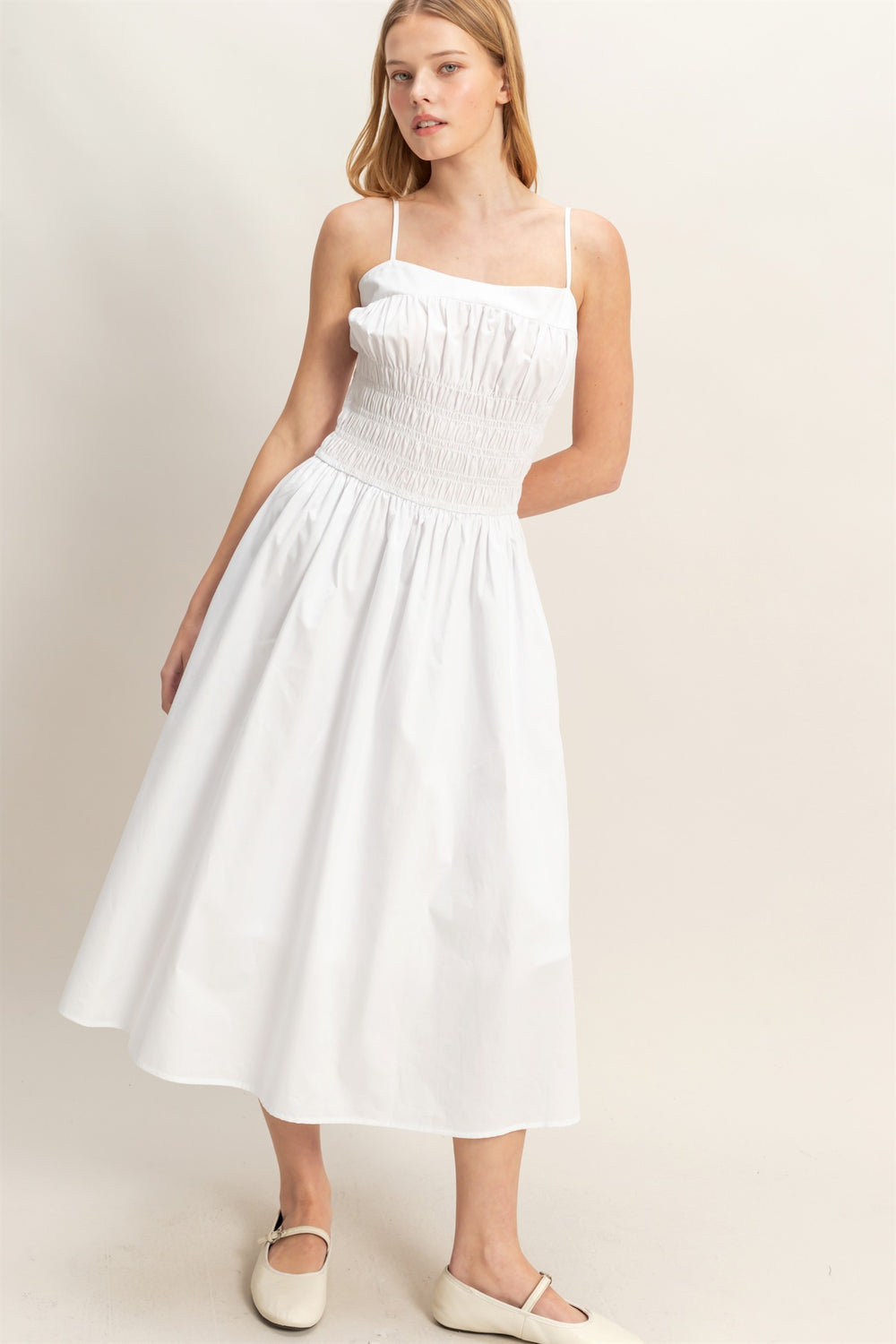 White Smocked Strapped Midi Dress with thin straps and a smocked bodice. Available in sizes XS–XL.