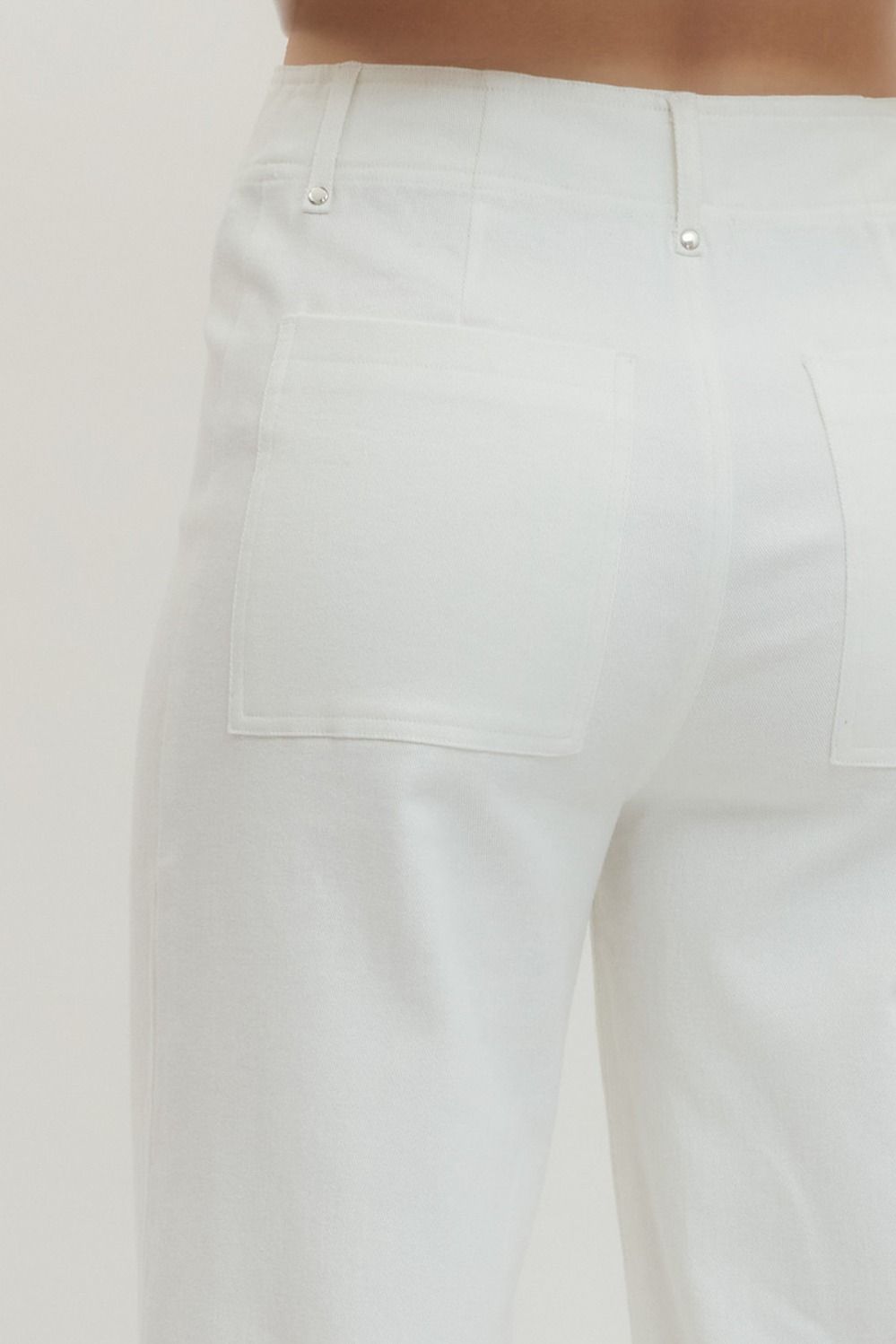 White HW Wide Leg Front Seam Pants with two square back pockets, silver rivets. Available in sizes XS-XL.