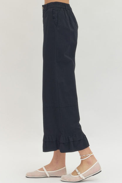 Black Straight Leg Ruffle Hem Pants available in sizes XS–XL.