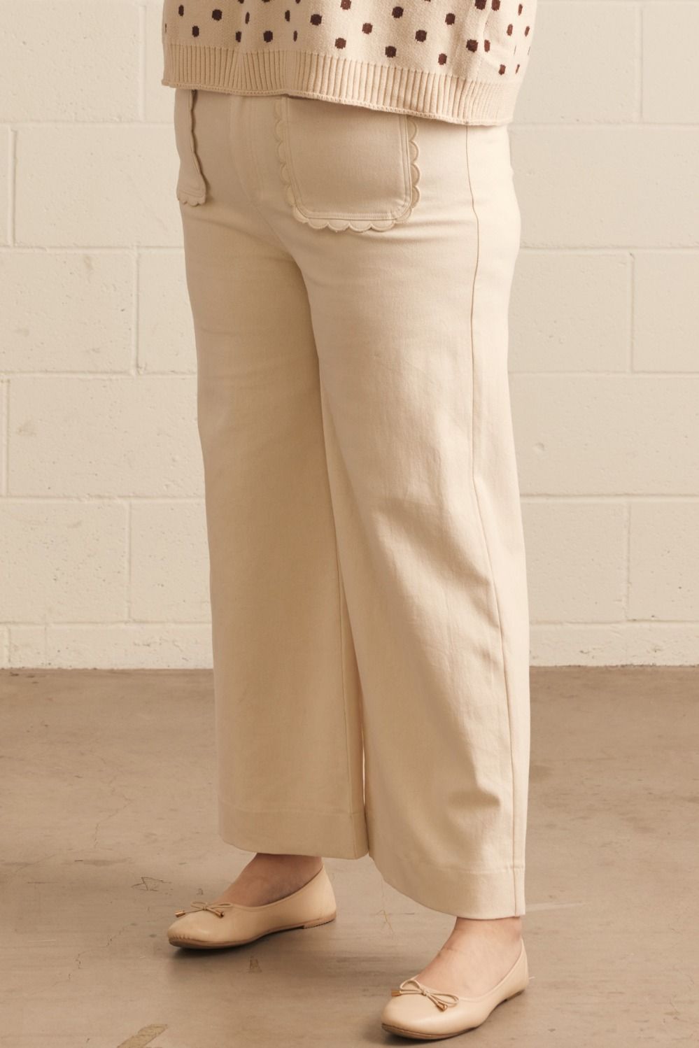 Madelyn Scallop Wide Leg Pants in cream with wide-leg tailoring and scalloped front pockets. Available in sizes XS-XL.