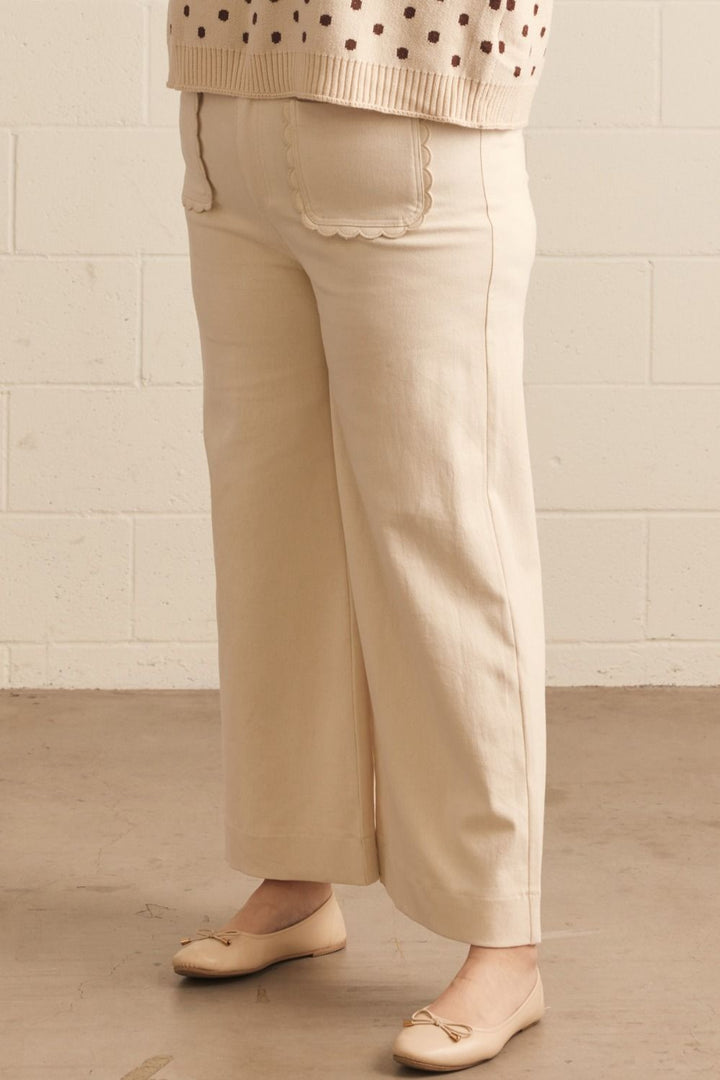 Madelyn Scallop Wide Leg Pants in cream with wide-leg tailoring and scalloped front pockets. Available in sizes XS-XL.