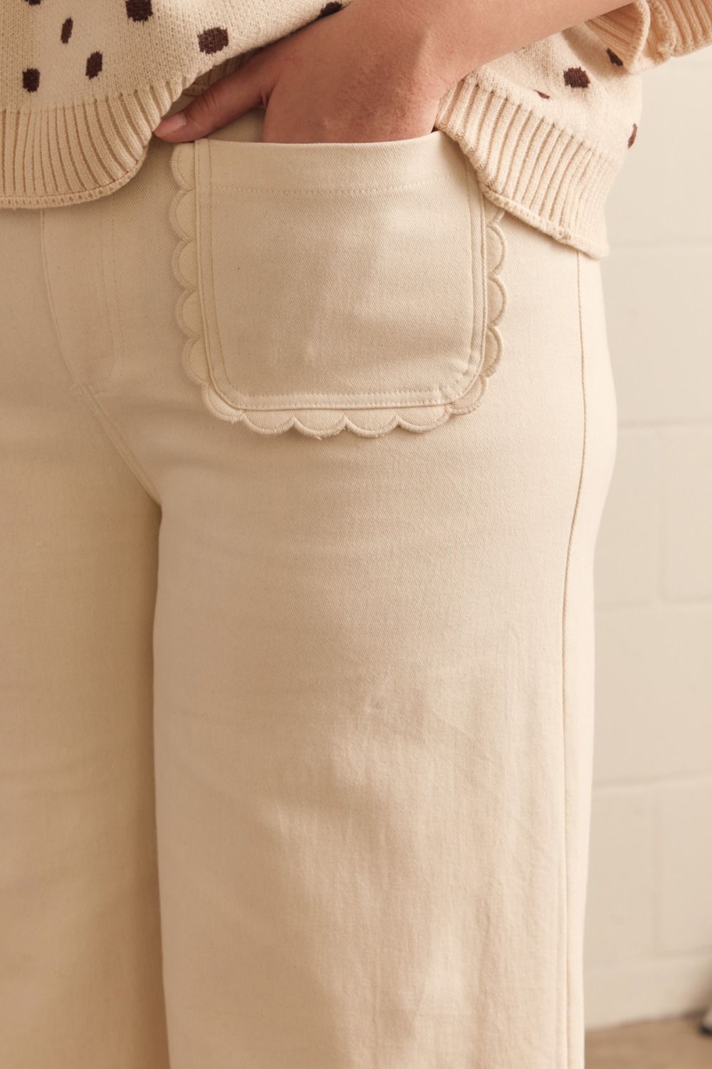 Madelyn Scallop Wide Leg Pants in cream with scallop-trimmed pocket; available in sizes XS–XL.