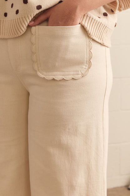 Madelyn Scallop Wide Leg Pants in cream with scallop-trimmed pocket; available in sizes XS–XL.