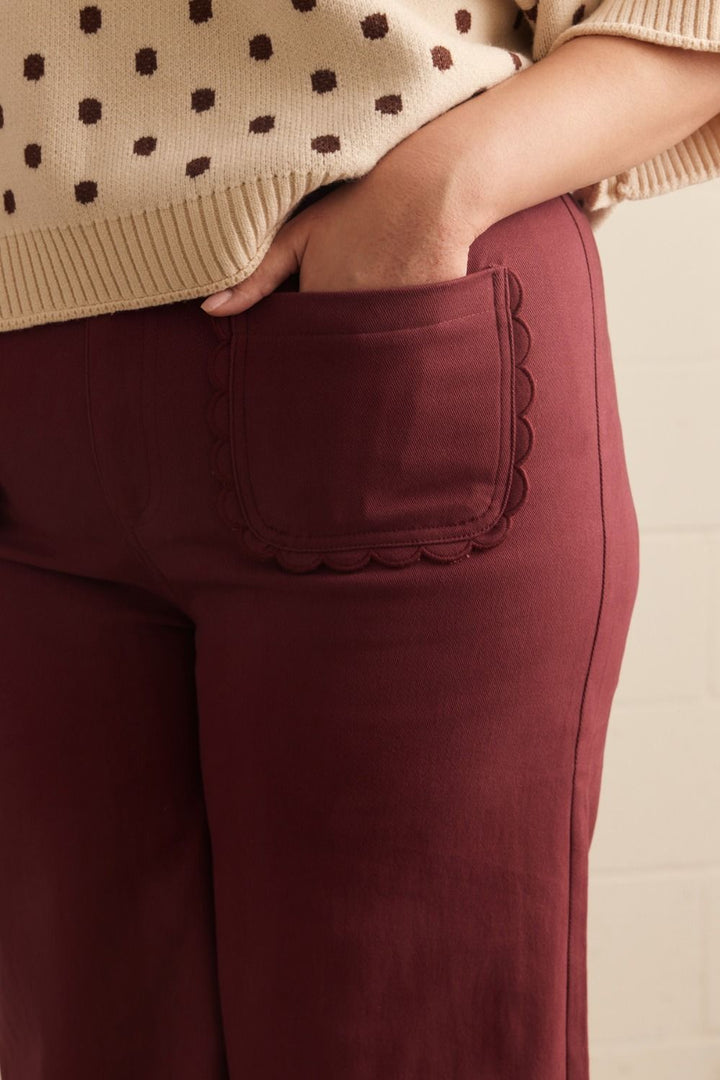 Madelyn Scallop Wide Leg Pants in maroon with scallop trim pocket. Available in sizes XS–XL.