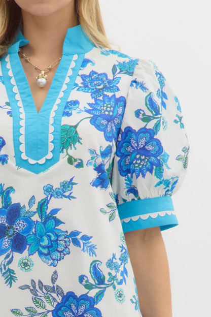 Blue Blossom Caftan Mini Dress with blue floral patterns, puffed short sleeves, turquoise accents, and A-line silhouette. Sizes: XS, S, M, L, XL.