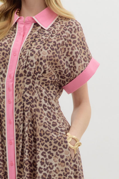 Leopard print midi dress featuring pink collar, cuffs, and button placket. Available in sizes XS–XL.