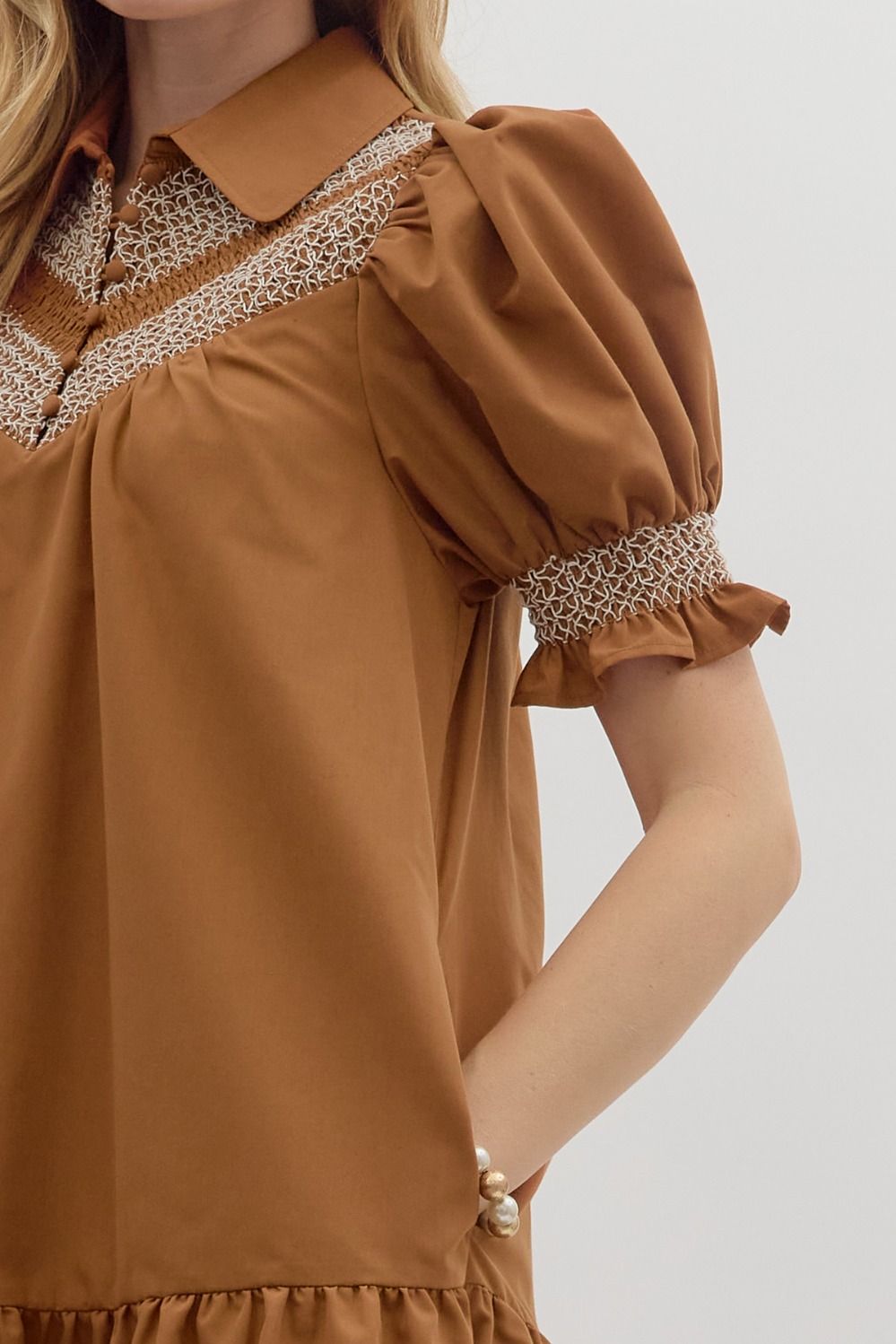 Sylvie Golden Hour Dress in caramel; puffed short sleeves, white smocking, collared neckline. Sizes: XS-XL.