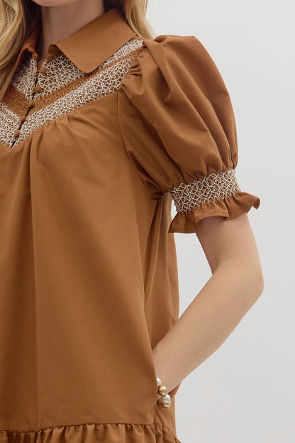 Sylvie Golden Hour Dress in caramel; puffed short sleeves, white smocking, collared neckline. Sizes: XS-XL.