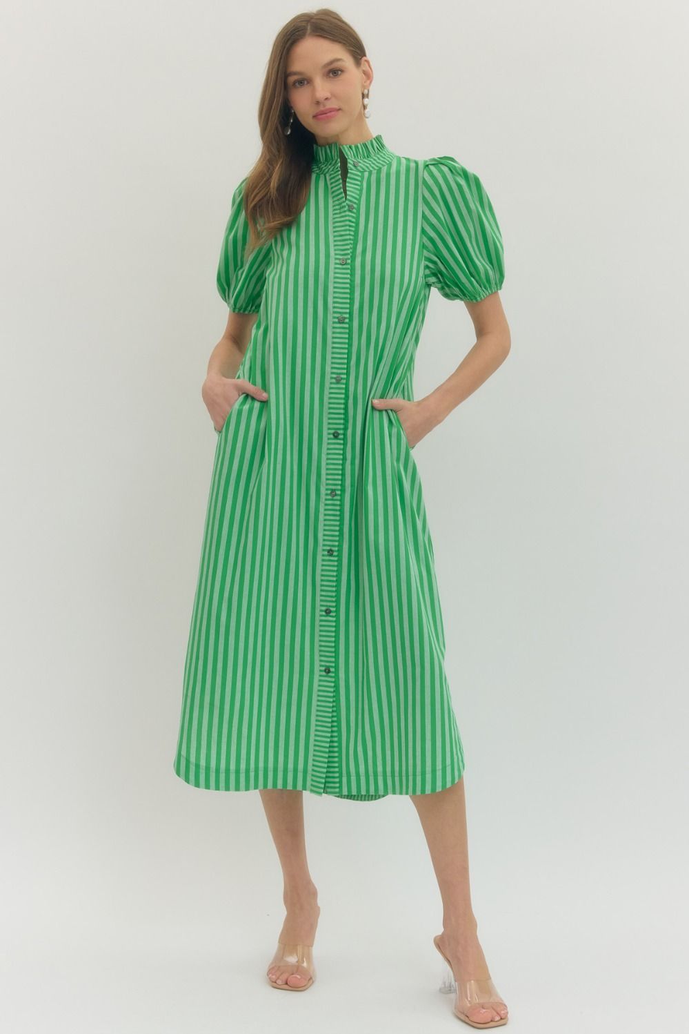 Green and white striped midi dress with ruffled neck, puff sleeves, pockets, button front. Available in sizes XS-XL.
