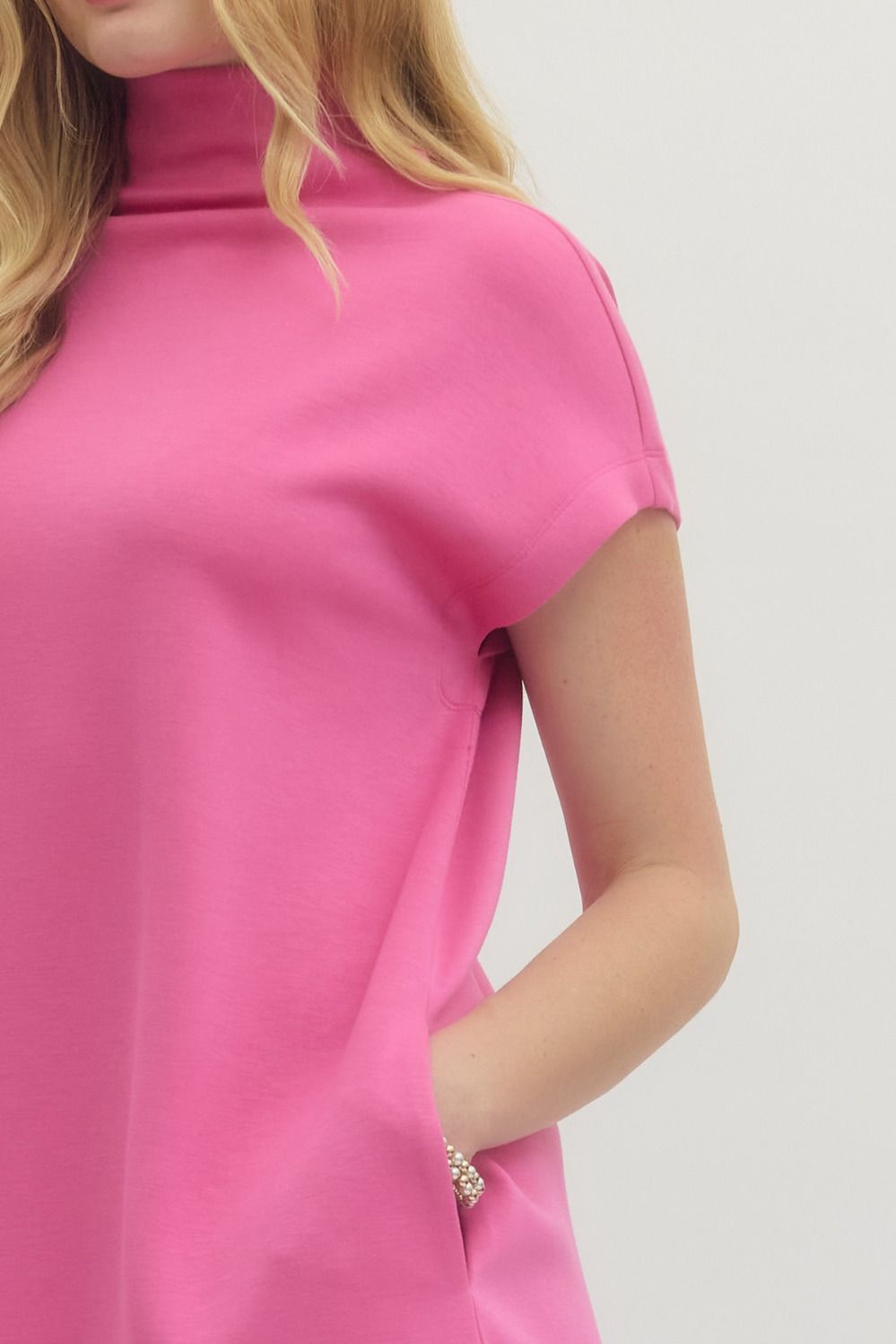 Pink Solid Mock Neck Pullover Dress with short sleeves and side pockets. Available in sizes XS-XL.