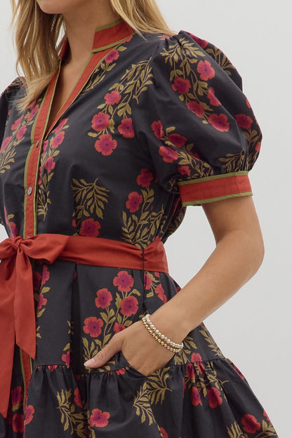 Angie Floral Puff Sleeve Ruffle Hem Dress in dark florals with puff sleeves, red trim, sash; available in sizes XS-XL.
