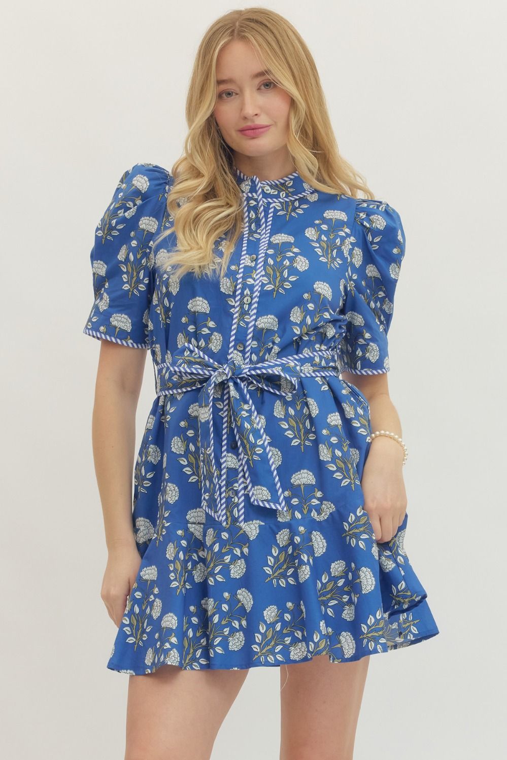 Blue Floral Print Belted Dress with puff sleeves, self-tie waist belt, ruffled hem. Available in sizes XS–XL.