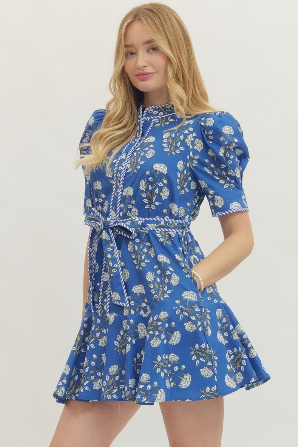 Blue Floral Print Belted Dress with white and green patterns, puffed sleeves, flared skirt, and self-tie belt. Sizes XS-XL.