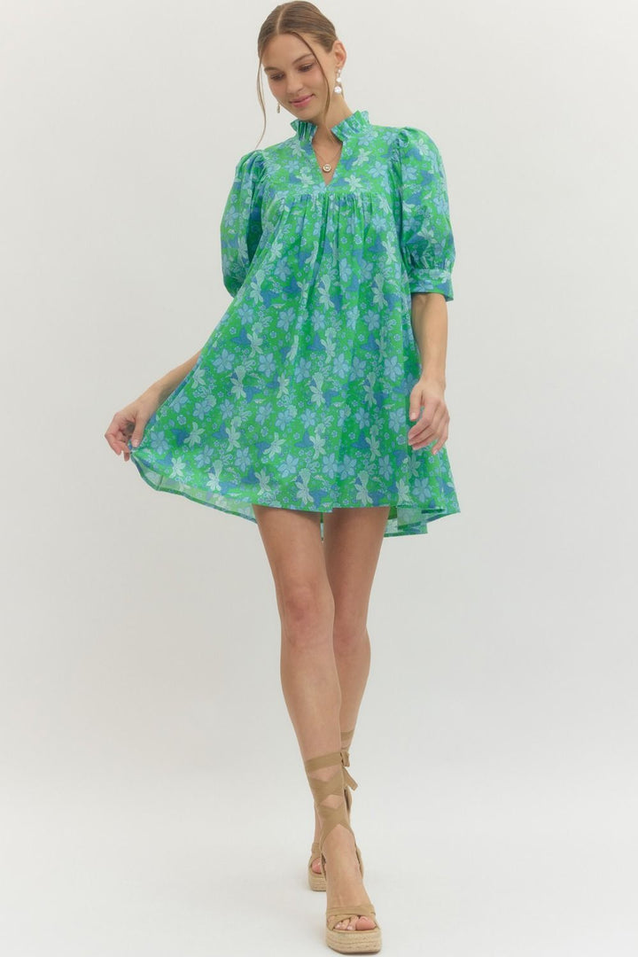 Green floral print dress with puff sleeves, ruffled neckline, stand collar. Available in sizes XS–XL.