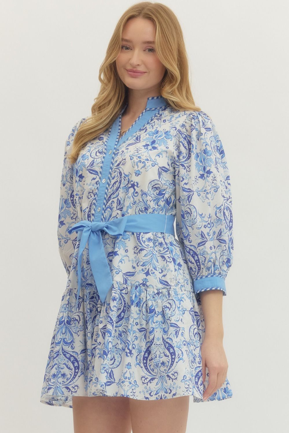 Royal Printed Long Sleeve Belted Dress in blue and white print, short hem. Available in sizes XS-XL.