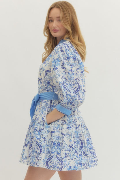 Royal Printed Long Sleeve Belted Dress in blue and white with puffy sleeves, matching belt. Available in sizes XS–XL.